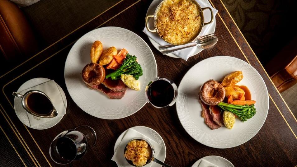 plates of roast dinners on a dark table
