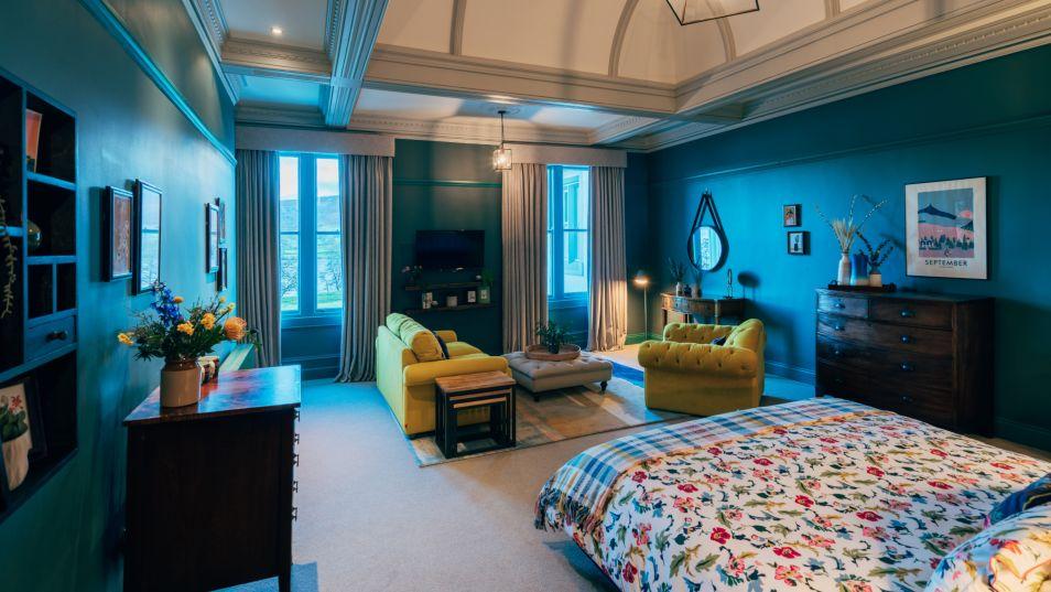 dark blue hotel room with plush furnishings